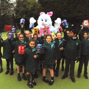 Easter bunny stood with children