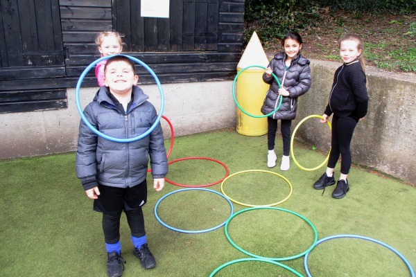 children playing with hola hoops