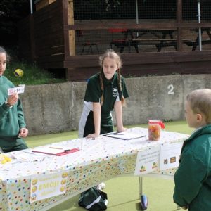 girls running a stall