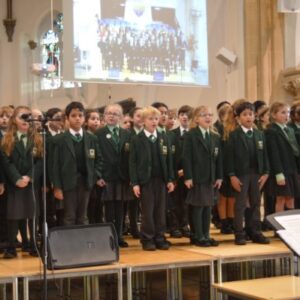 children on a stage singing